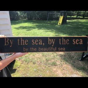 “By the sea” wall sign